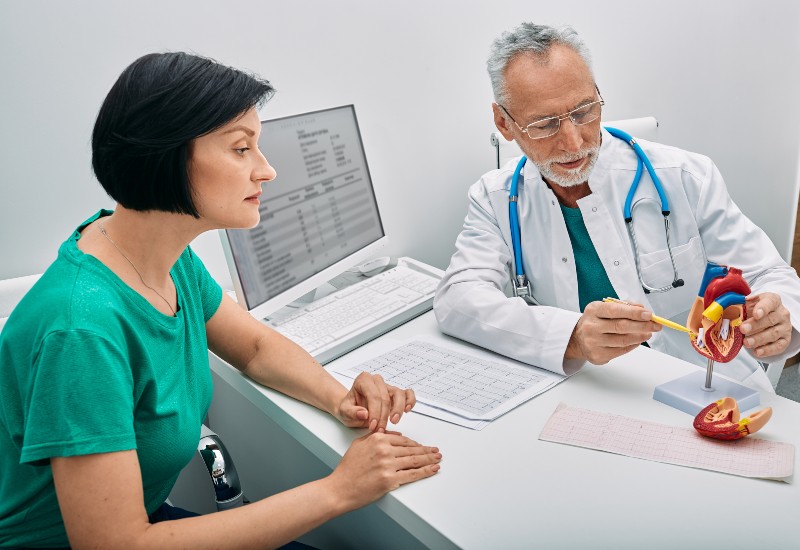 Cardiology consultation. Male doctor cardiologist consulting female patient with heart problems SSUCv3H4sIAAAAAAAACpySy27DIBBF95X6DxbrIGHwi/5K1cUAkxiVmAjjVFWUfy9+ELGuF5bnDHPnzuDH+1tVEQWz1eSjeqxRiq1zyxwDROunhNnp4AEng6Ek9yA6VgI0NvpgwZVQQdTjBFdMcFqcW/FzS5I5QlxmnNfuB9IQ8ZI0dviS2C1+7nGVE1syVaQUIaeCzYvaWEa7+L8q94+vPA1ccNK/m+FikIAOYR/k8EiYUlwMnaIDbzragJBUpYca1na6V4PpGp47EwSljKkllapjtEHNKQxoKAphVMtlLRRslnYf5PsnYriWe4PFWF+s7O41uPWAKGzegtV2uhRlPo7bneYy7ZcphnW+11qI8/4Gyq33d06amPkI85yOm8yLRjr9Qf5a9Jl83LZzqBKTrnkNa8GlbCVntRRSDC1nx4H91xht0tnsZKEU629rytHt6oDoppayUYY2QqYXYksH1pwpawVq2cu+r+u0wucfAAAA//8DAO5C6Zb1AgAA